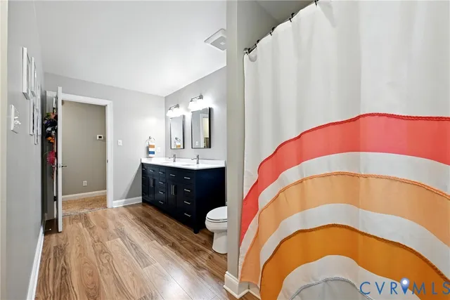 a spacious bedroom with a bed and a sink