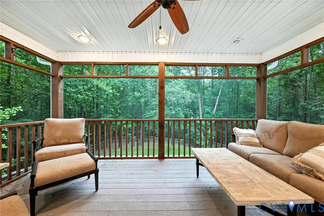 a balcony with furniture and a large window