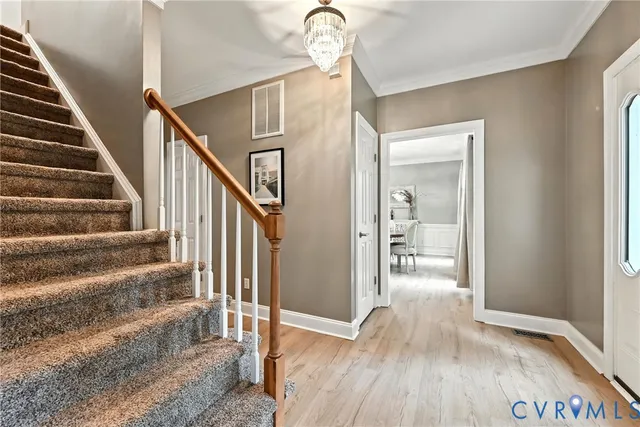 a view of entryway and hall with wooden floor