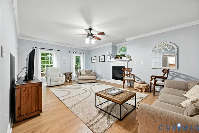 a living room with furniture a fireplace and a flat screen tv