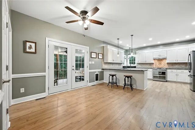 a living room with stainless steel appliances kitchen island granite countertop furniture and a kitchen view