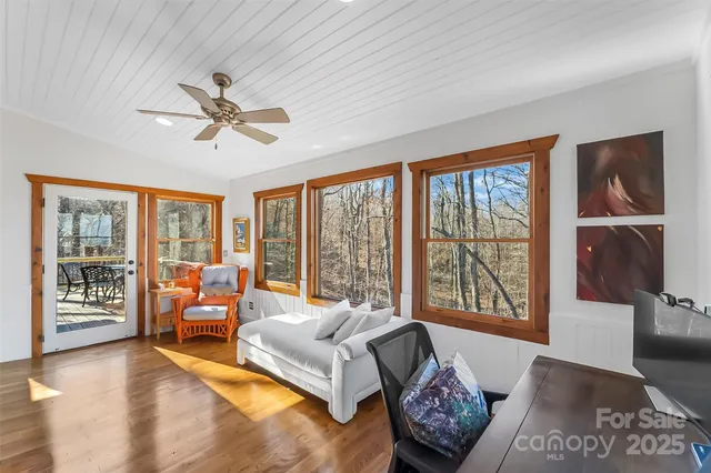 a living room with furniture and floor to ceiling windows