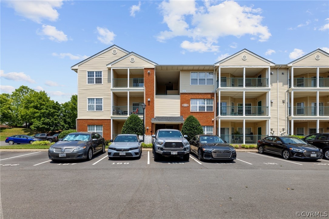 910 Masters Row, Unit J Glen Allen, VA 23059 - Photo 1 of 17 a car parked in front of a building