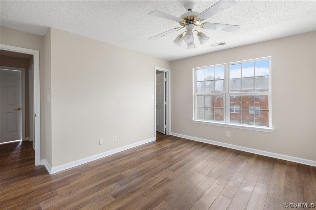 910 Masters Row, Unit J Glen Allen, VA 23059 - Photo 11 of 17 wooden floor in an empty room with a window