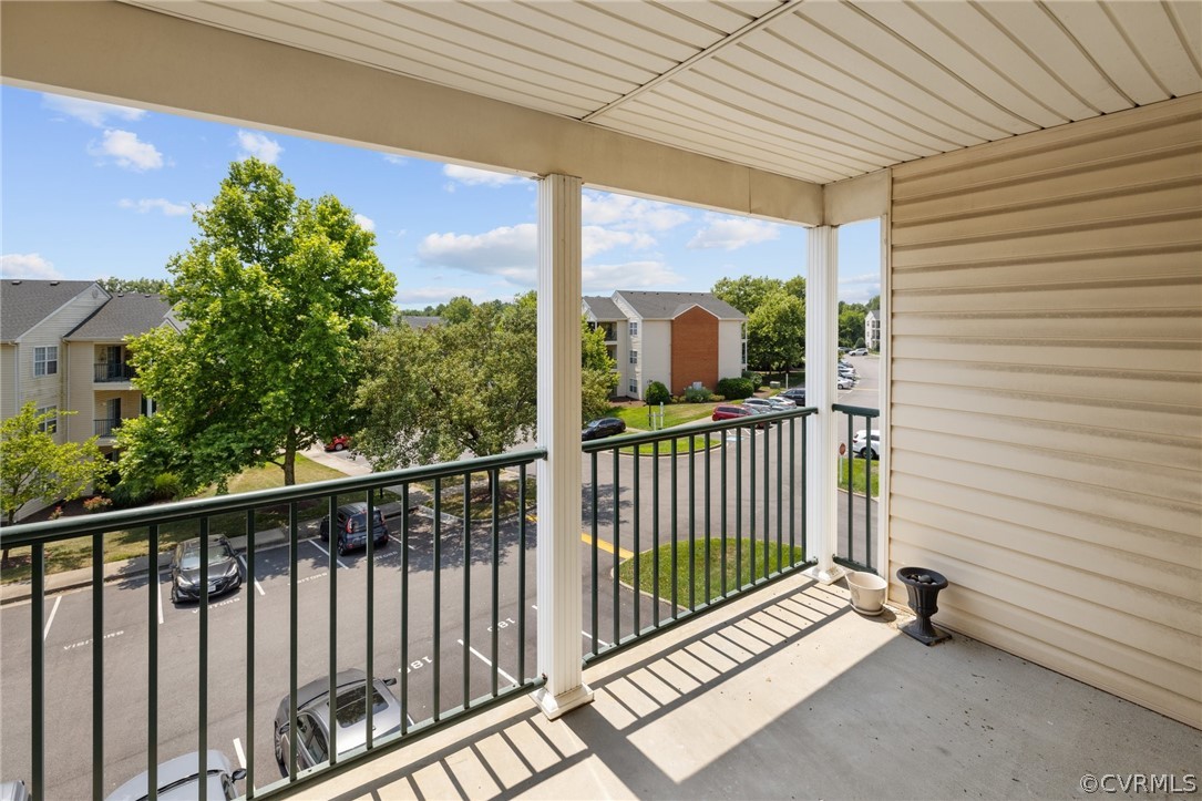 910 Masters Row, Unit J Glen Allen, VA 23059 - Photo 16 of 17 a view of balcony with floor to ceiling window and wooden fence
