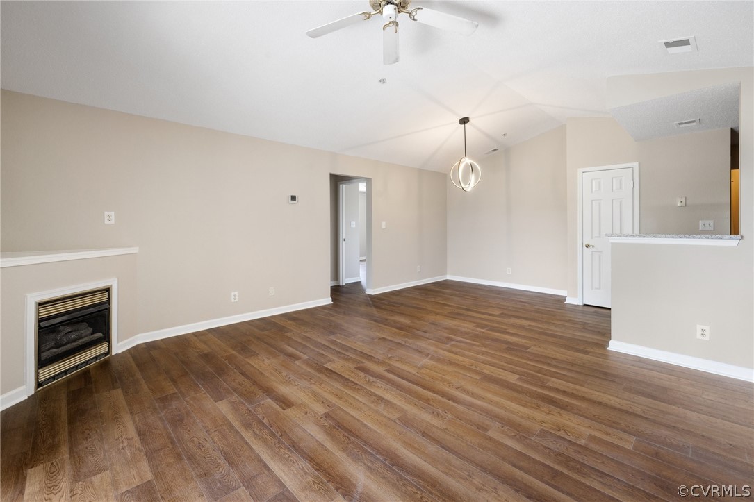 910 Masters Row, Unit J Glen Allen, VA 23059 - Photo 3 of 17 a view of empty room with wooden floor and fireplace