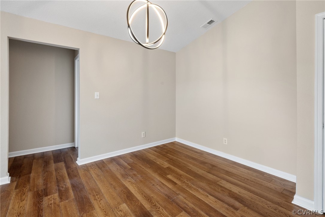 910 Masters Row, Unit J Glen Allen, VA 23059 - Photo 6 of 17 a view of a room with wooden floor and white walls