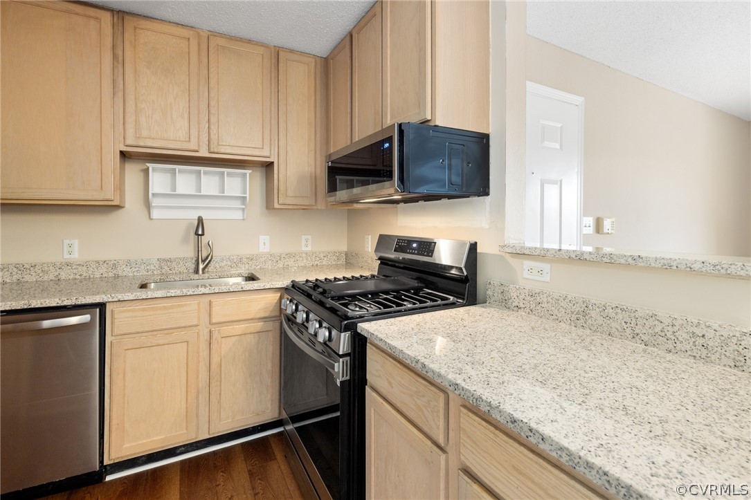 910 Masters Row, Unit J Glen Allen, VA 23059 - Photo 7 of 17 a kitchen with granite countertop cabinets stainless steel appliances and a sink
