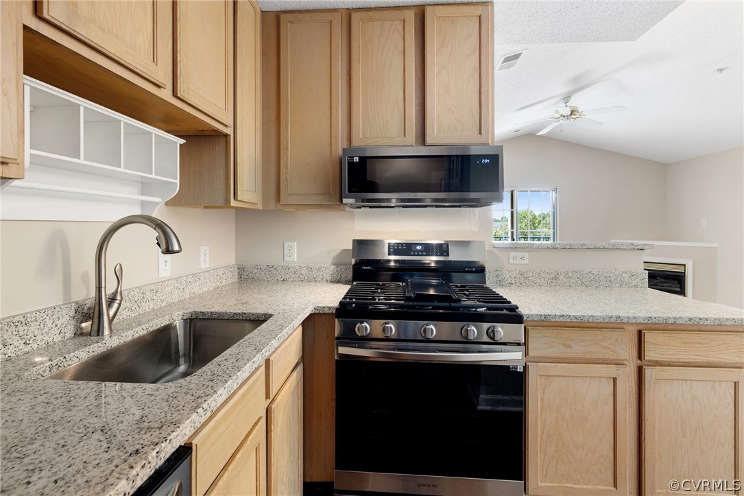 910 Masters Row, Unit J Glen Allen, VA 23059 - Photo 8 of 17 a kitchen with stainless steel appliances granite countertop a sink a stove and a microwave