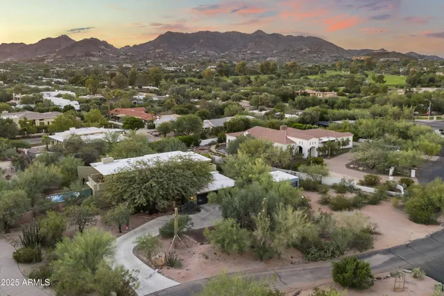 an aerial view of houses covered in trees