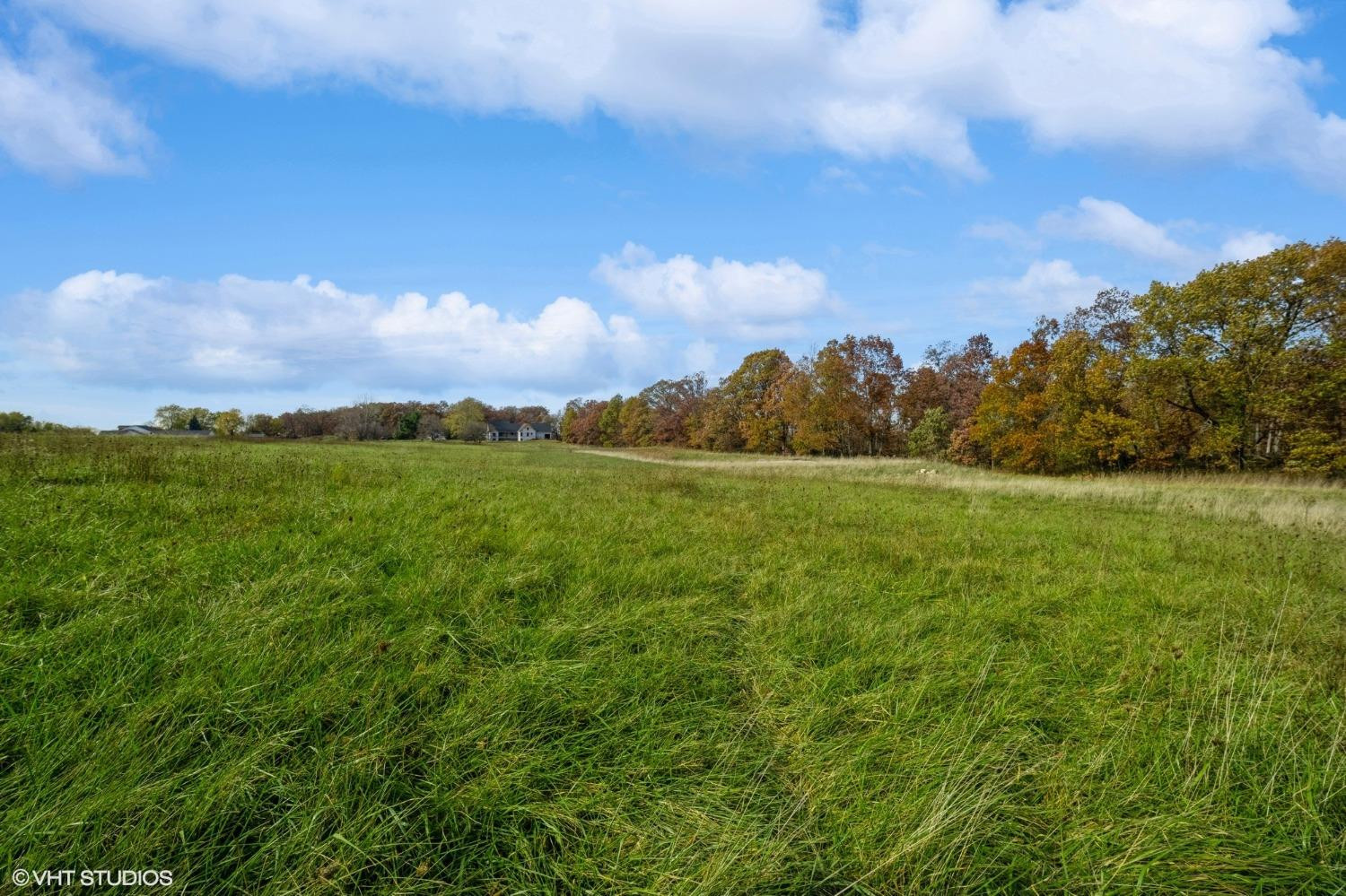 595 West 213 South Hebron, IN 46341 - Photo 1 of 25 a view of a field with an ocean and trees in the background