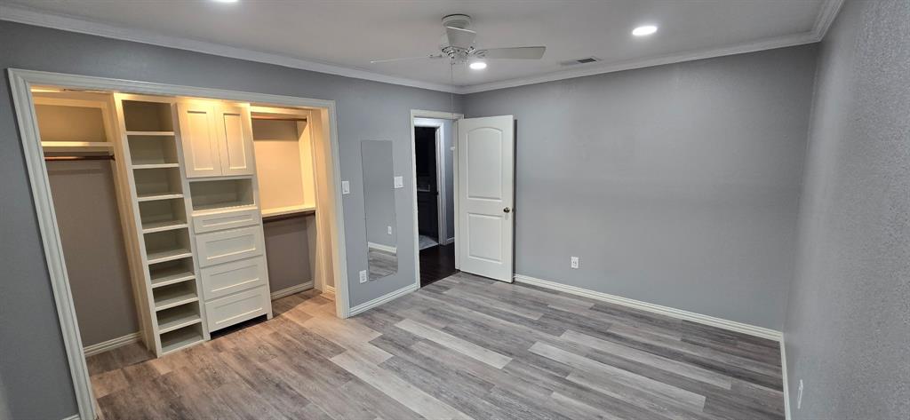 509 Royal Valley Road Grand Prairie, TX 75052 - Photo 11 of 22 an empty room with wooden floor and windows