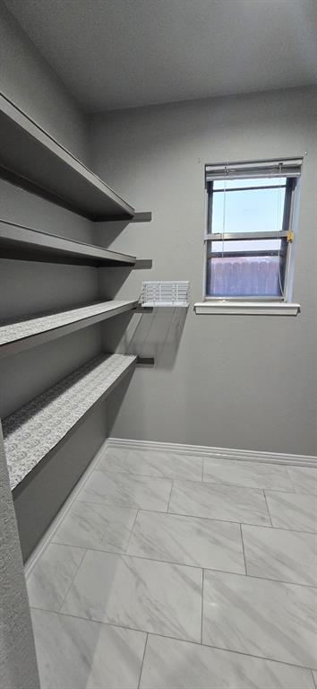 509 Royal Valley Road Grand Prairie, TX 75052 - Photo 18 of 22 a view of room with window and cabinet