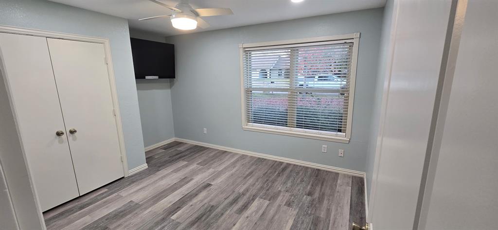 509 Royal Valley Road Grand Prairie, TX 75052 - Photo 10 of 22 a view of an empty room with wooden floor and a window