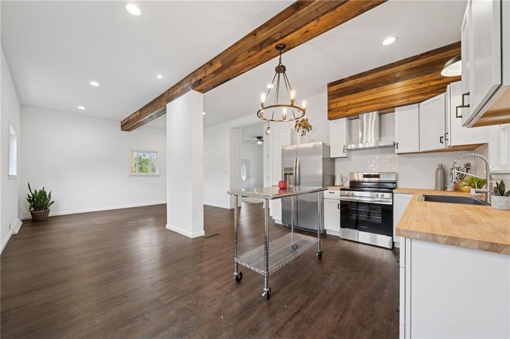 124 Oak Street Yukon, PA 15698 - Photo 13 of 35 a kitchen with a refrigerator and a stove top oven