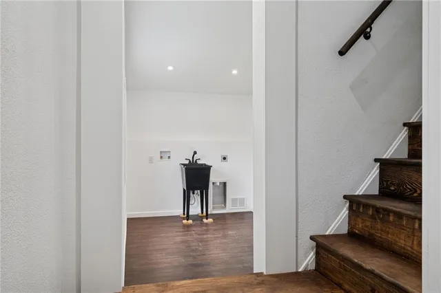 a bedroom with a large bed and a potted plant