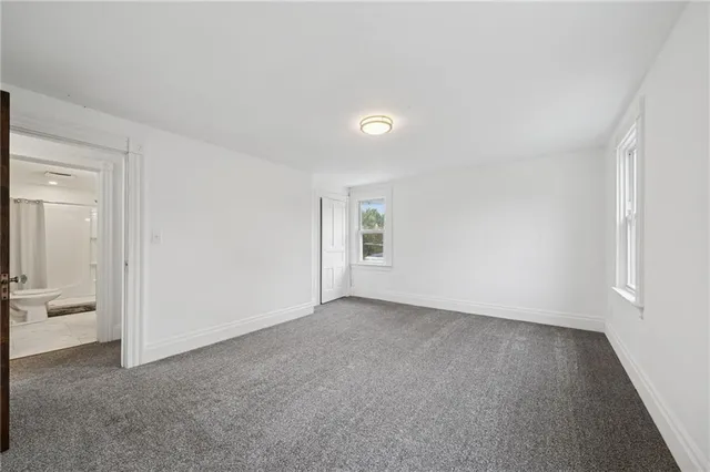 a view of an empty room and closet area