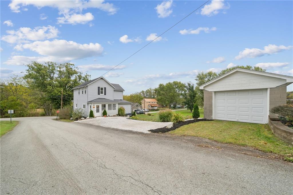 124 Oak Street Yukon, PA 15698 - Photo 31 of 35 a front view of a house with a yard and garage