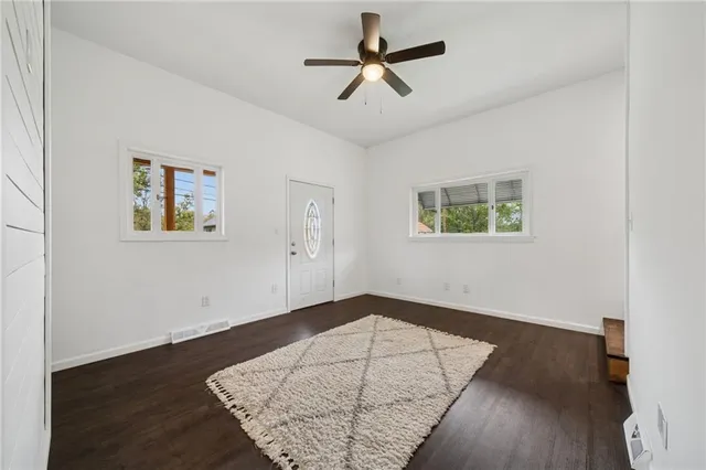 a view of empty room with wooden floor