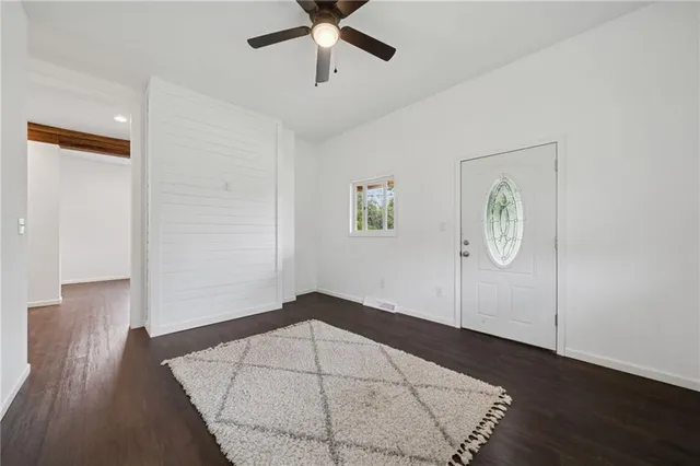a view of empty room with wooden floor