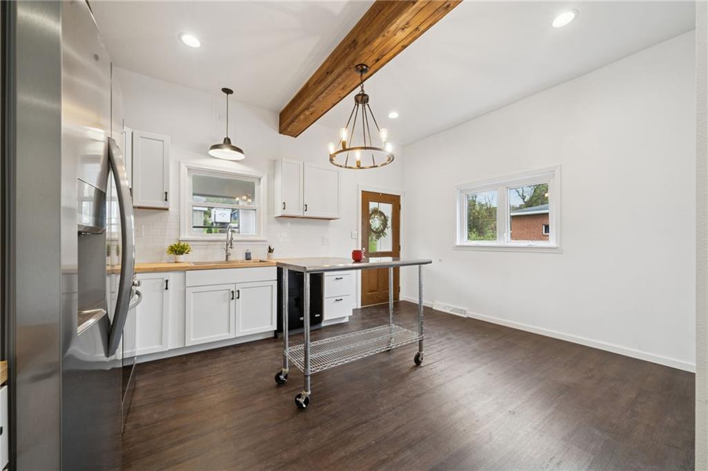 124 Oak Street Yukon, PA 15698 - Photo 7 of 35 a kitchen with a refrigerator a sink cabinets and wooden floor