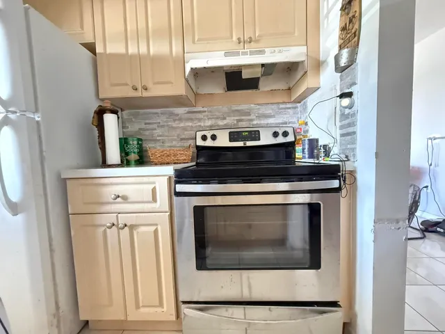 a stove top oven sitting inside of a kitchen