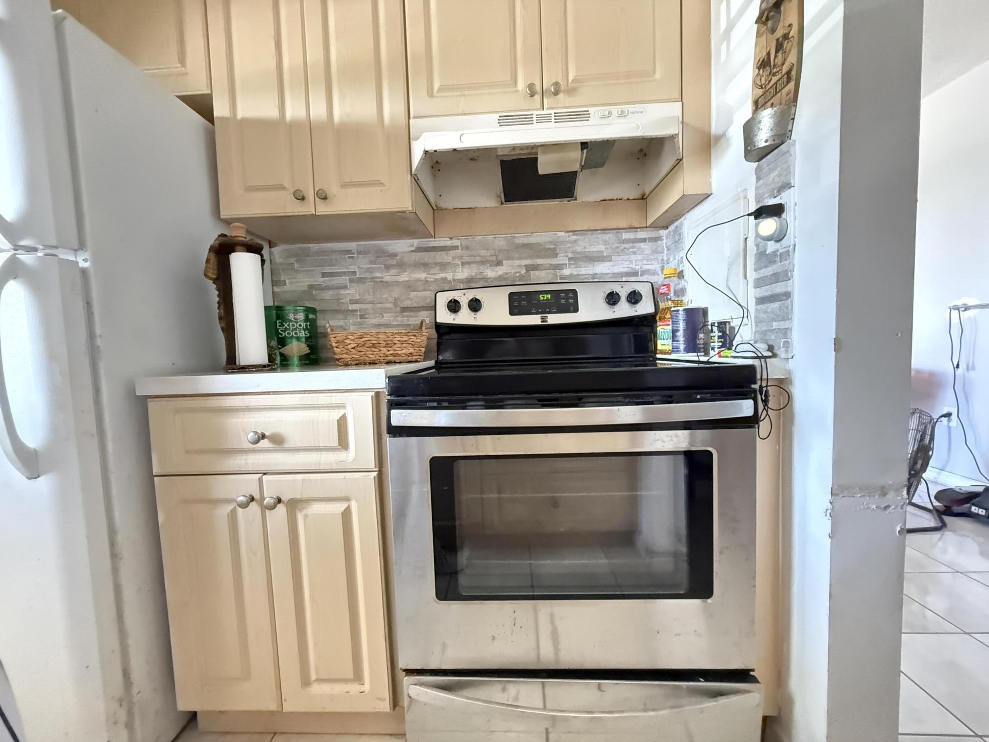 17001 Northeast 13th Avenue, Unit 205 Miami, FL 33162 - Photo 5 of 14 a stove top oven sitting inside of a kitchen