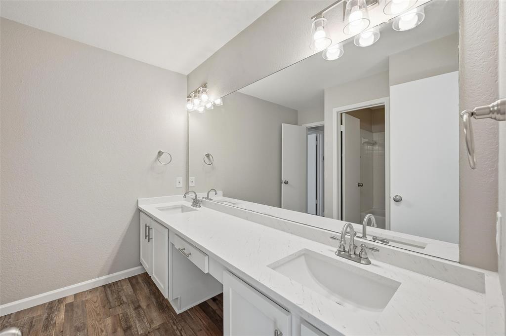 705 Timberoaks Drive Azle, TX 76020 - Photo 17 of 27 a bathroom with a sink vanity granite and a mirror