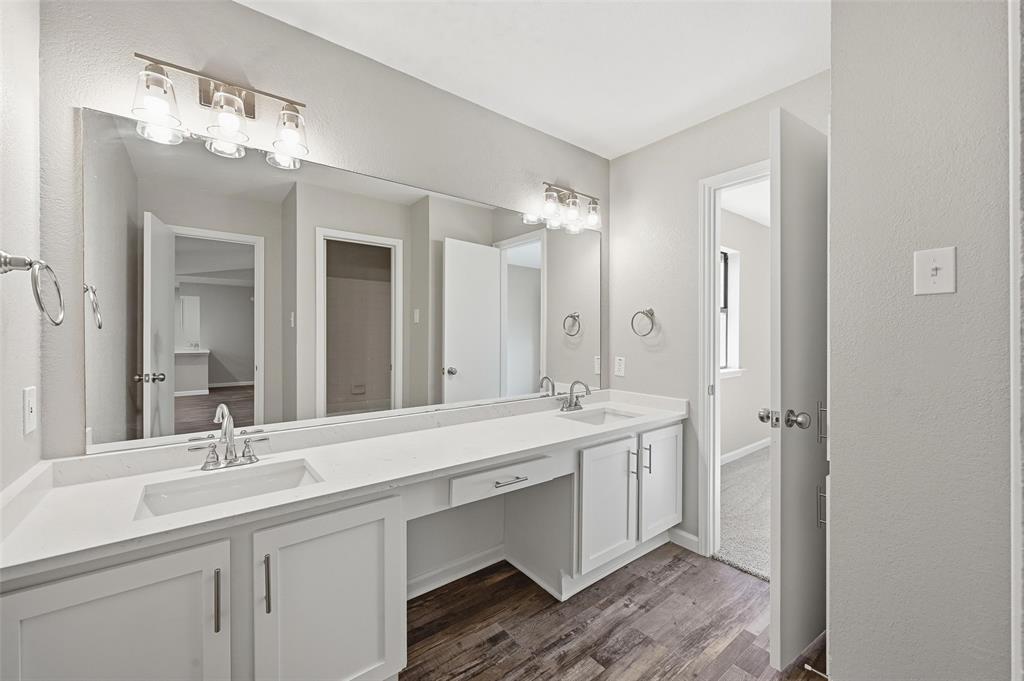 705 Timberoaks Drive Azle, TX 76020 - Photo 19 of 27 a bathroom with a double vanity sink and a mirror