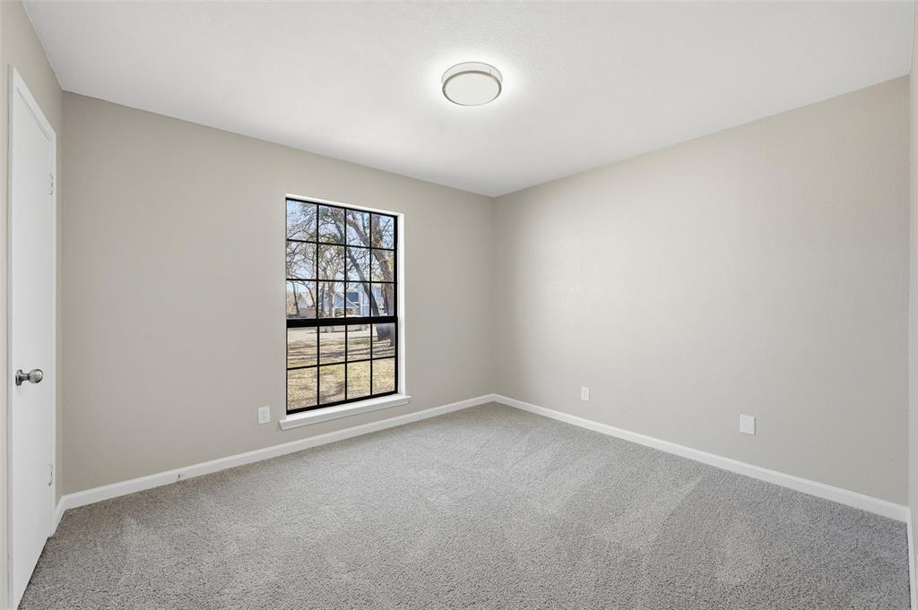 705 Timberoaks Drive Azle, TX 76020 - Photo 22 of 27 an empty room with windows