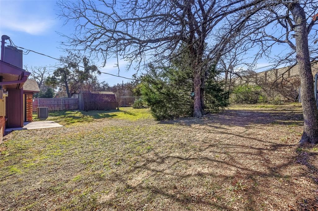 705 Timberoaks Drive Azle, TX 76020 - Photo 26 of 27 a view of a yard with plants and large trees