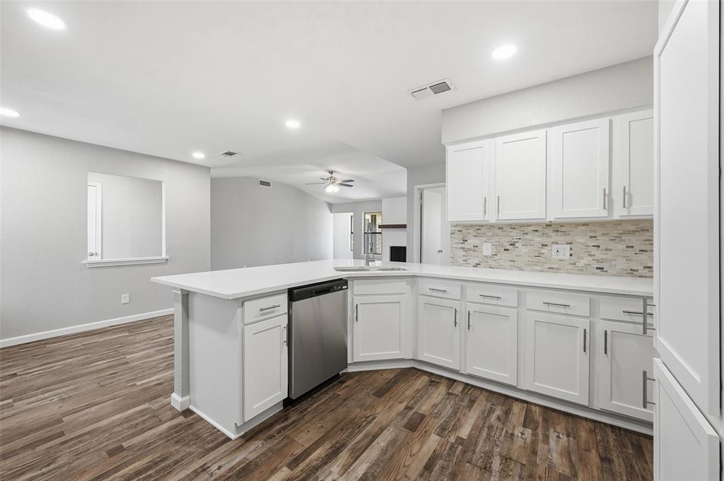 705 Timberoaks Drive Azle, TX 76020 - Photo 4 of 27 a kitchen with granite countertop white cabinets and white appliances