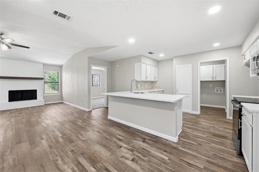 705 Timberoaks Drive Azle, TX 76020 - Photo 5 of 27 a view of kitchen with wooden floor and electronic appliances