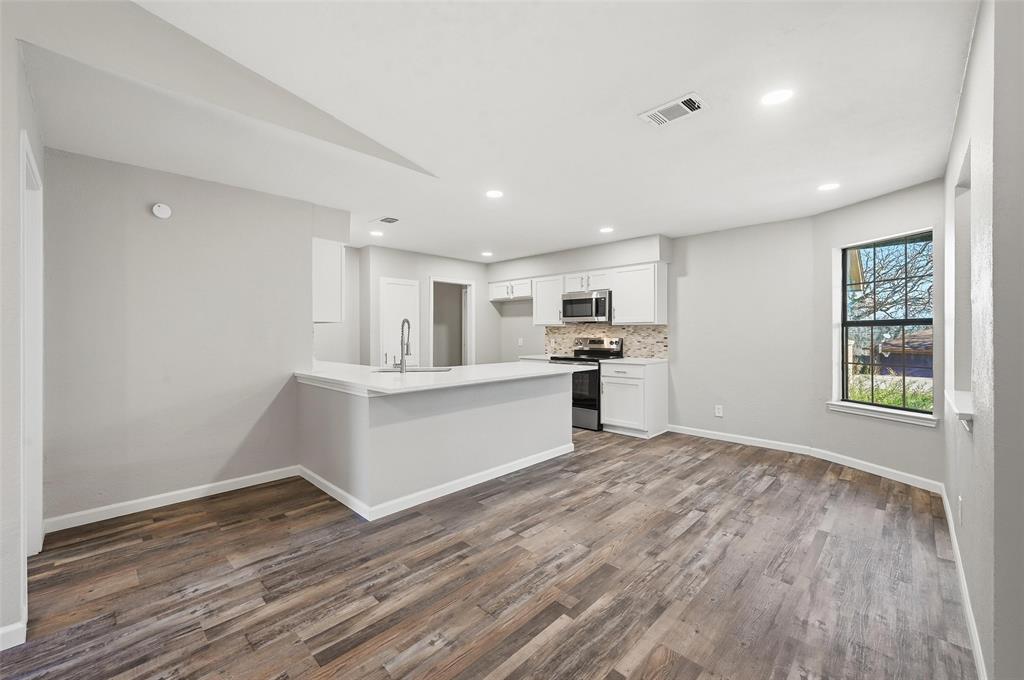 705 Timberoaks Drive Azle, TX 76020 - Photo 6 of 27 a view of kitchen with wooden floor and electronic appliances