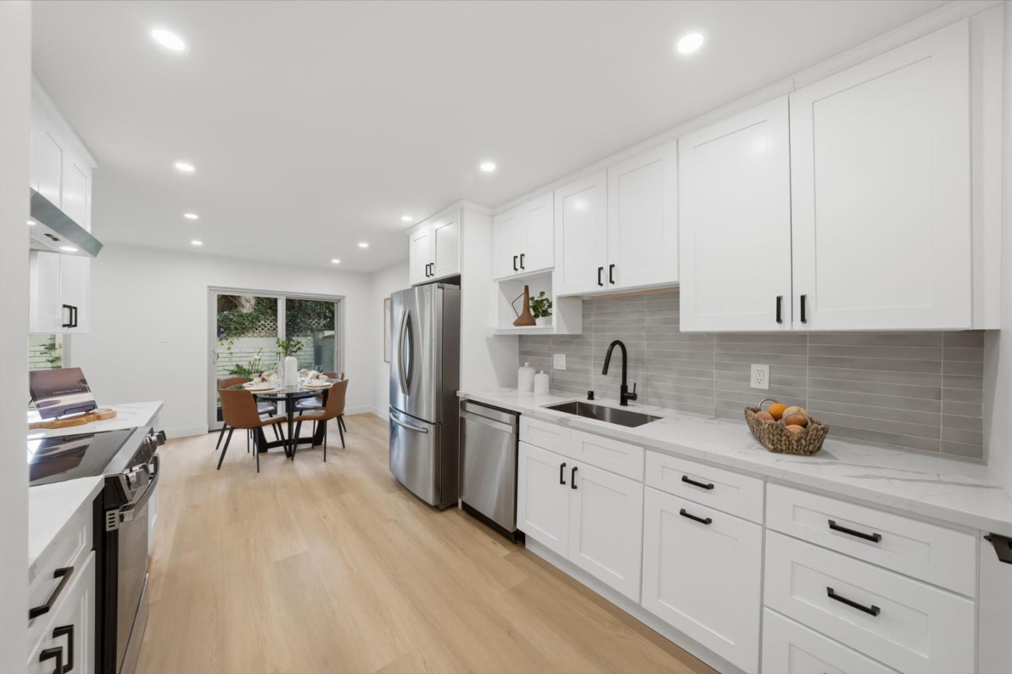 409 Puerto Place Hayward, CA 94541 - Photo 21 of 54 a kitchen with stainless steel appliances white cabinets sink and wooden floor
