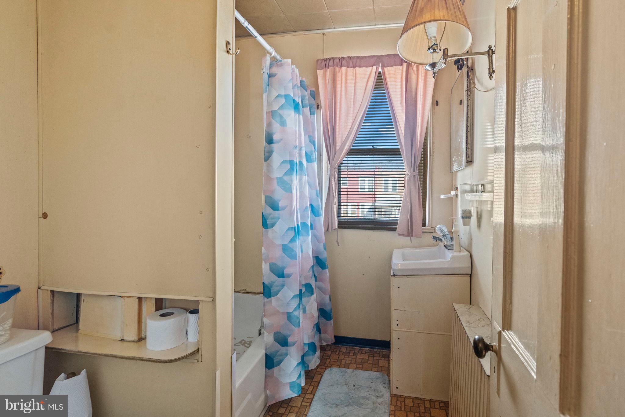 2892 North Constitution Road Camden, NJ 08104 - Photo 12 of 17 a bathroom with a shower curtain and a window