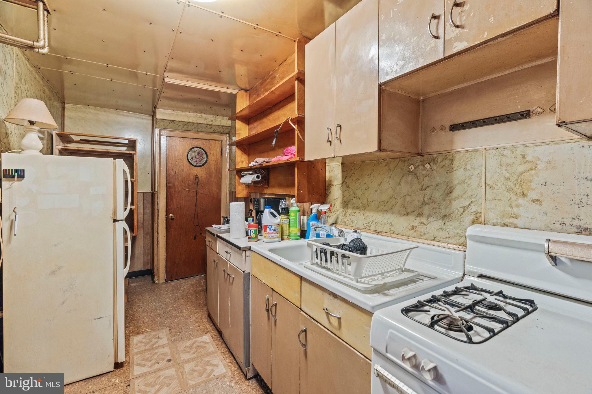 2892 North Constitution Road Camden, NJ 08104 - Photo 7 of 17 a kitchen with a stove and a refrigerator