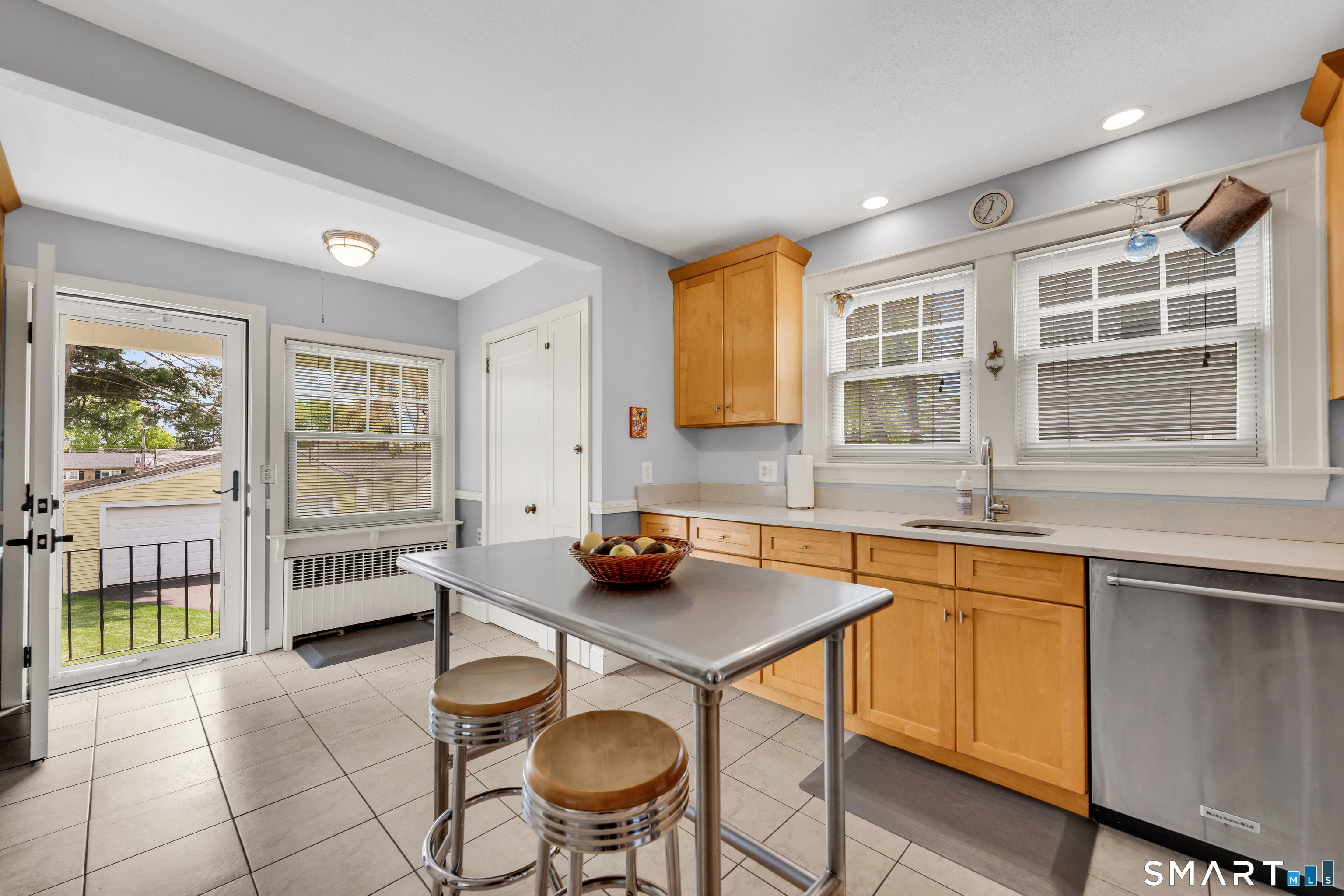 44 Beverly Road Wethersfield, CT 06109 - Photo 8 of 31 a kitchen that has a sink and chairs in it