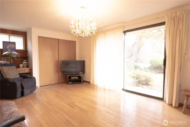 a view of a room with furniture a chandelier and a large window