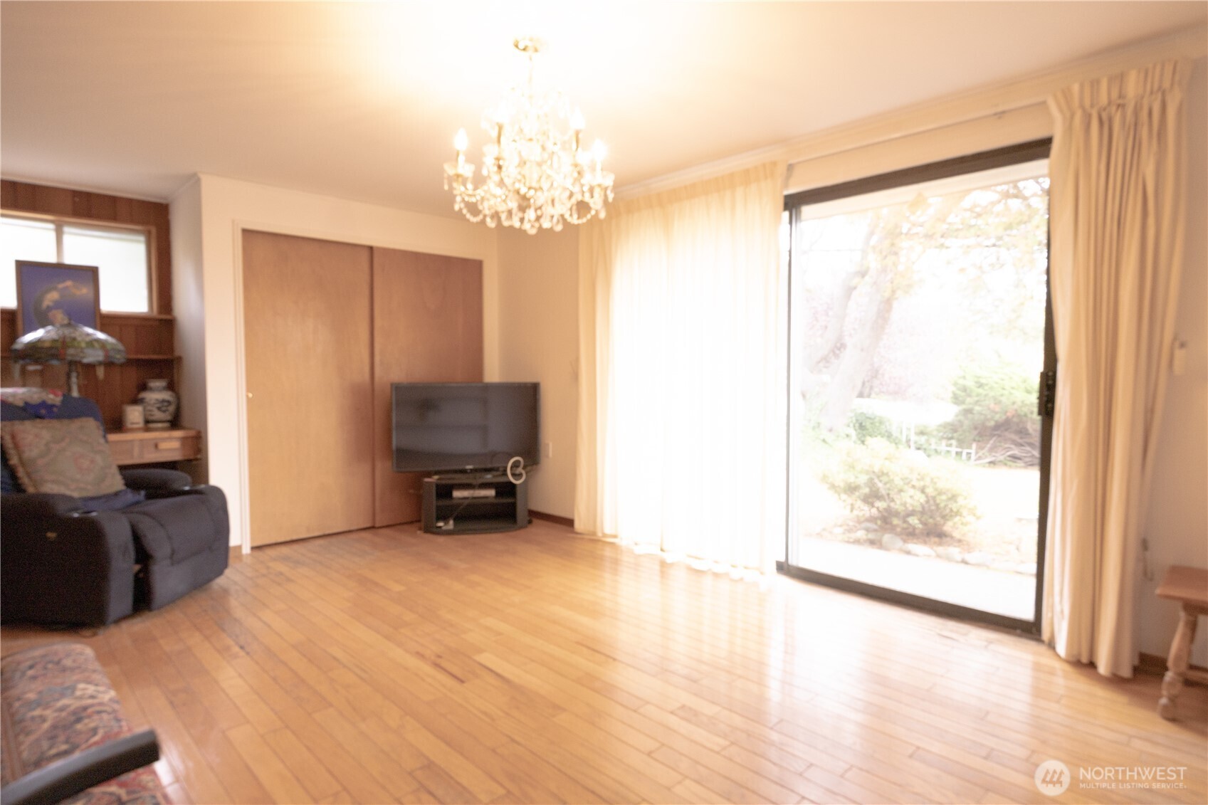2105 100th Avenue Northeast Bellevue, WA 98004 - Photo 13 of 14 a view of a room with furniture a chandelier and a large window