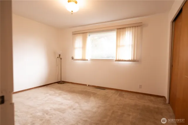 a view of a room with furniture a chandelier and a large window