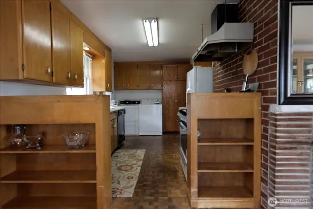 a kitchen with a refrigerator and cabinets