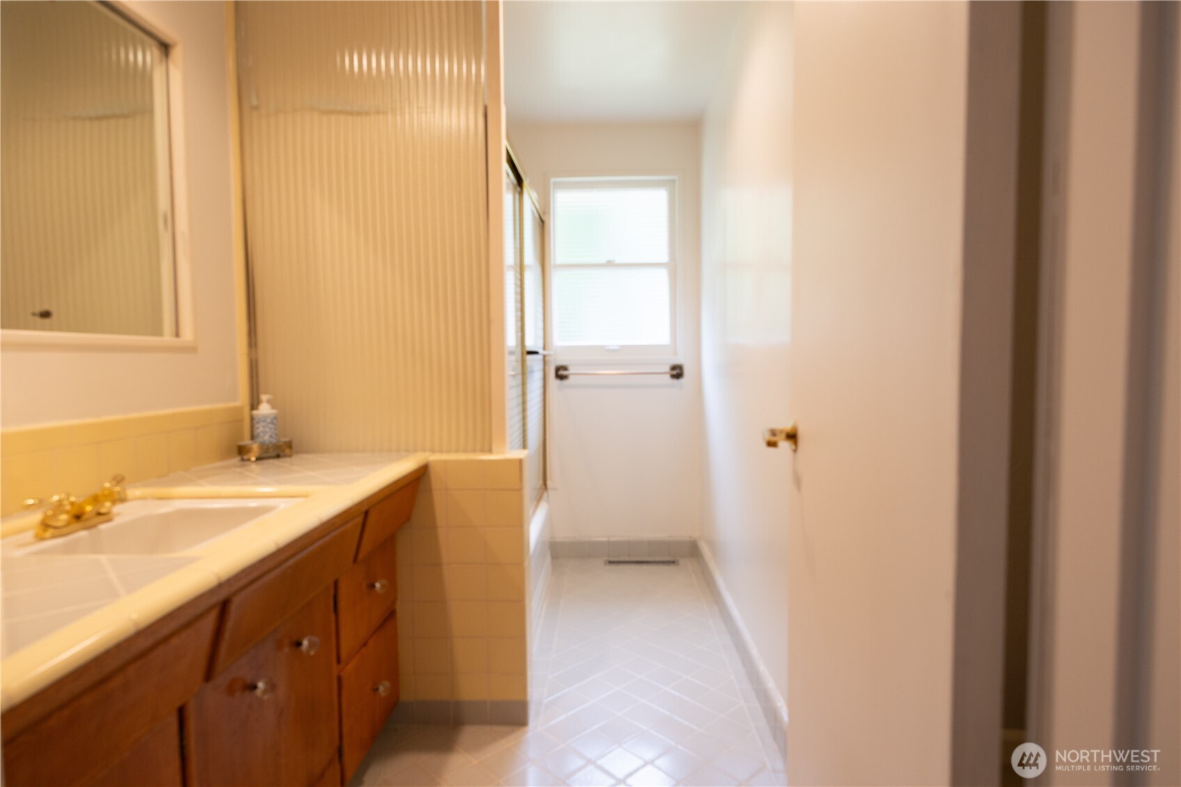 2105 100th Avenue Northeast Bellevue, WA 98004 - Photo 8 of 14 a bathroom with a sink and a mirror