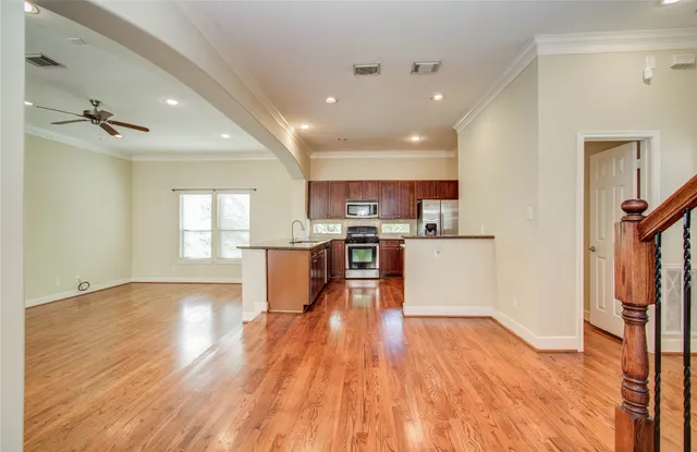 a view of a livingroom with furniture wooden floor and windows