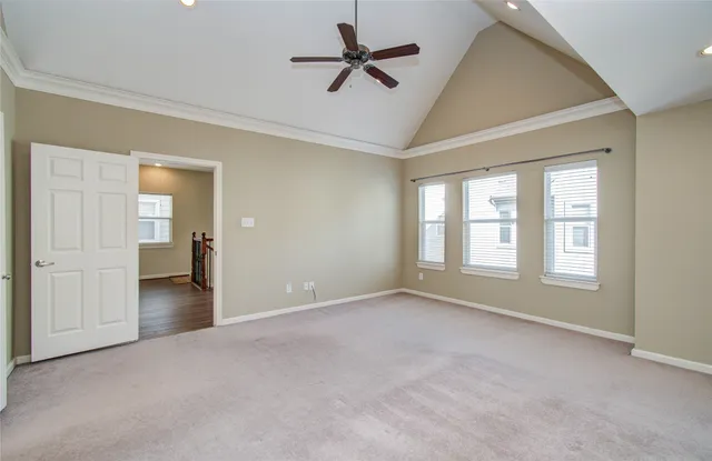 a view of an empty room with window and closet area