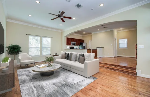 a living room with furniture and a wooden floor