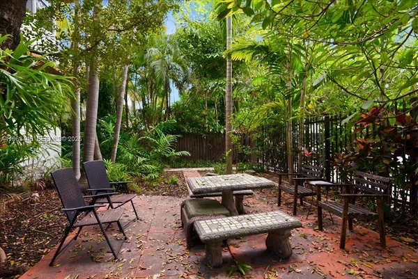 a view of a patio with table and chairs and potted plants