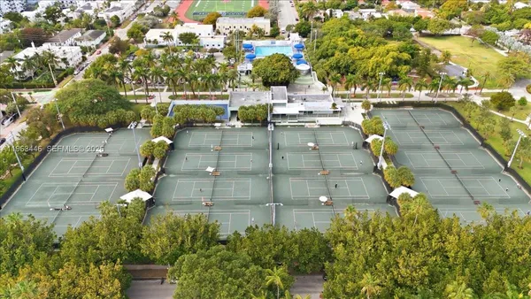 an aerial view of residential houses with yard