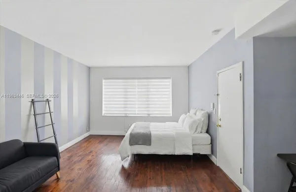 a bedroom with furniture and a wooden floor
