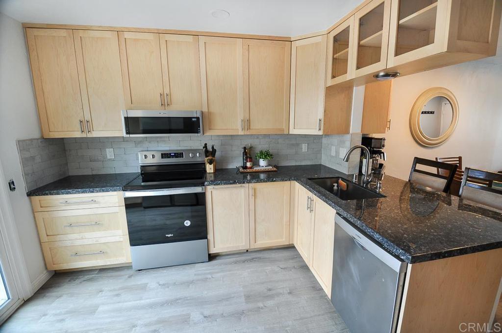 10155 Carefree Drive Santee, CA 92071 - Photo 9 of 19 a kitchen with stainless steel appliances granite countertop a sink a stove and cabinets